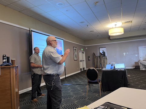 A man gestures while speaking.